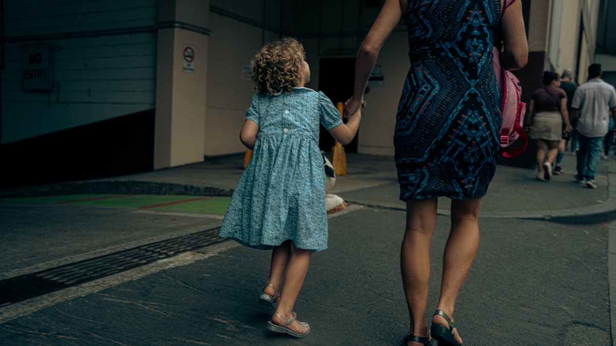 Parent tenant la main d’un enfant